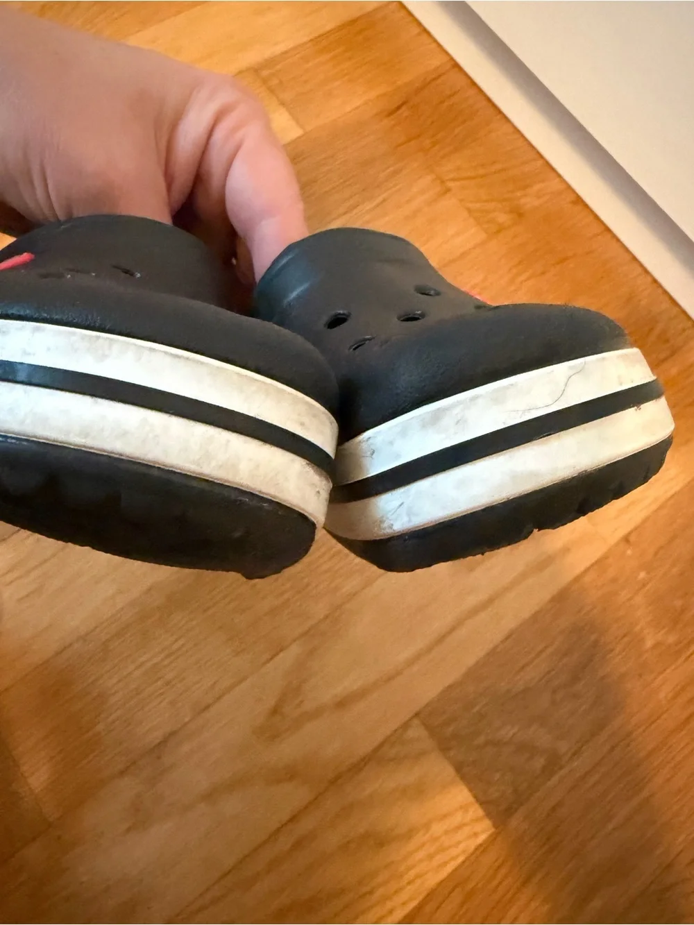 Kid’s black Croc slip on shoe with white band size 8